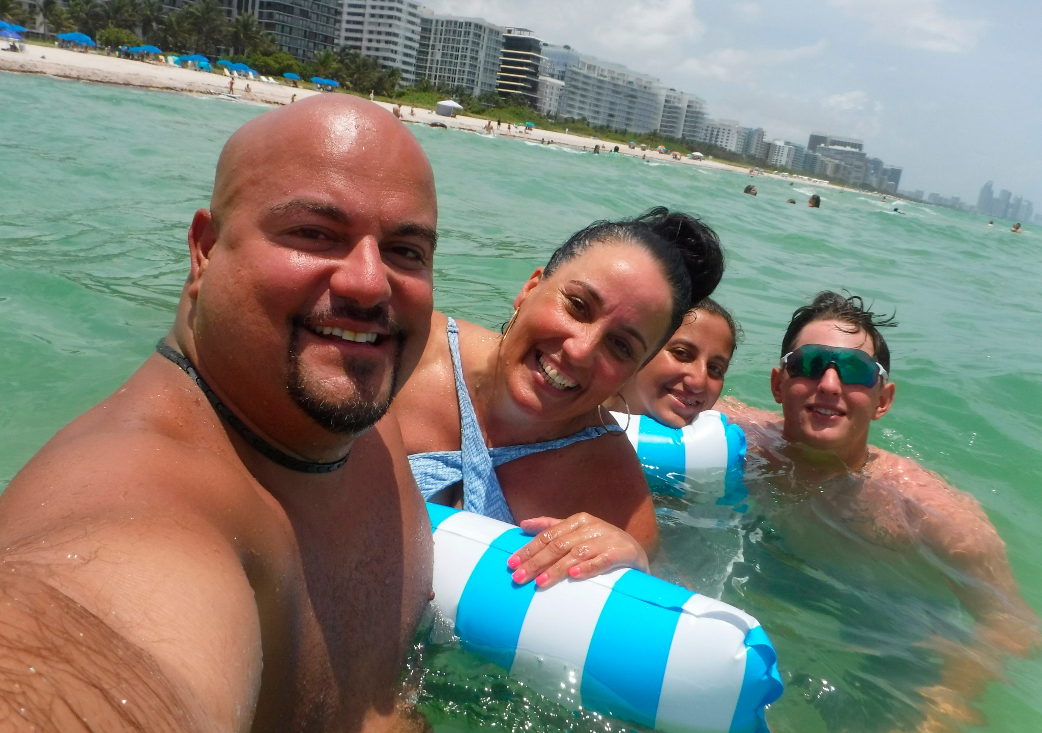 This Wednesday, June 23, 2021, photo provided by Albert Aguero shows him, his wife, Janette; 14-year-old daughter, Athena, and 22-year-old son, Justin Willis, vacationing in the Miami area from New Jersey. They all were able to escape the building collapse of Champlain Towers South the following day. “When I opened the staircase door and half the staircase was missing, at that point I know we’re racing against time to all get out as a family,” Albert Aguero says. (Albert Aguero via AP)