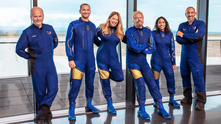 This image provided by Virgin Galactic shows, from left: Chief Pilot Dave Mackay, Lead Operations Engineer Colin Bennett, Chief Astronaut Instructor Beth Moses, Founder of Virgin Galactic Richard Branson, Vice President of Government Affairs and Research Operations Sirisha Bandla and pilot Michael Masucci. (Virgin Galactic via Associated Press)