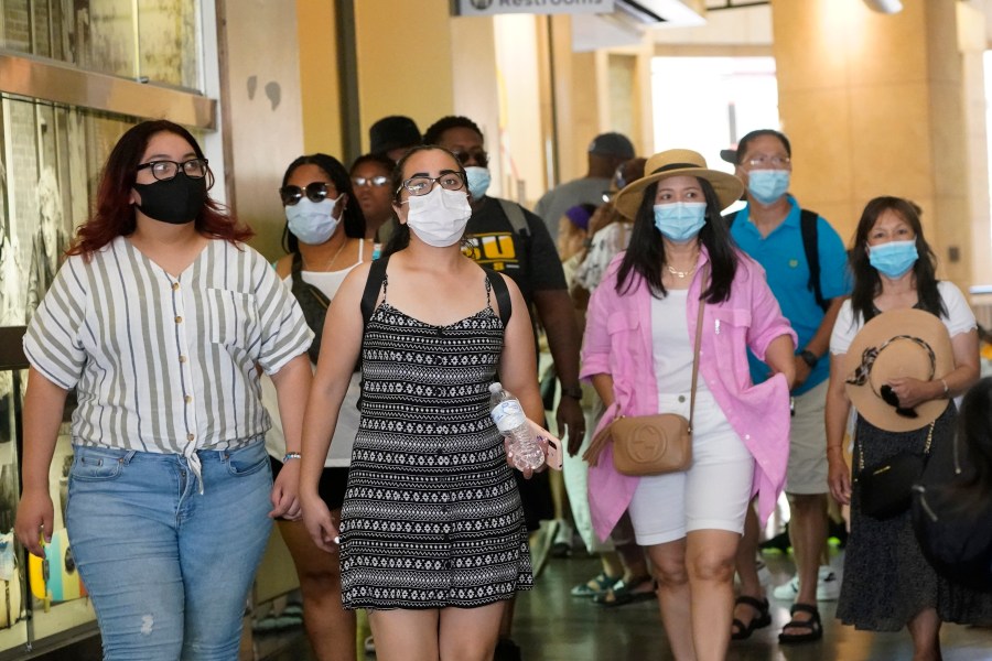 Visitors wear masks as they walk in a shopping district Thursday, July 1, 2021, in the Hollywood section of Los Angeles. (AP Photo/Marcio Jose Sanchez)