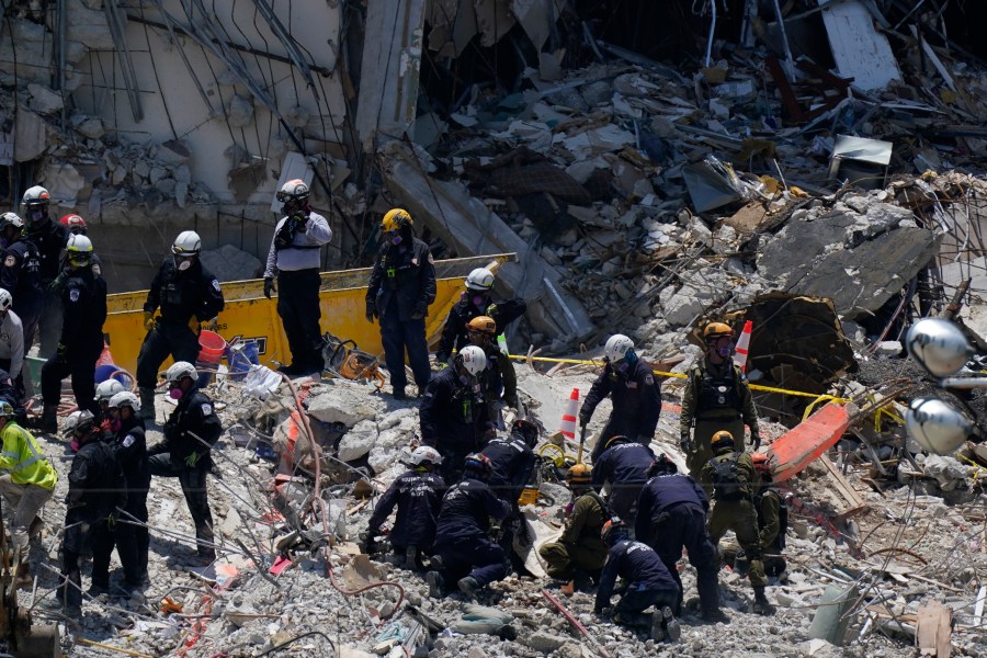 Search and rescue personnel work atop the rubble at the Champlain Towers South condo building, where scores of victims remain missing more than a week after it partially collapsed, Friday, July 2, 2021, in Surfside, Fla. (AP Photo/Mark Humphrey)