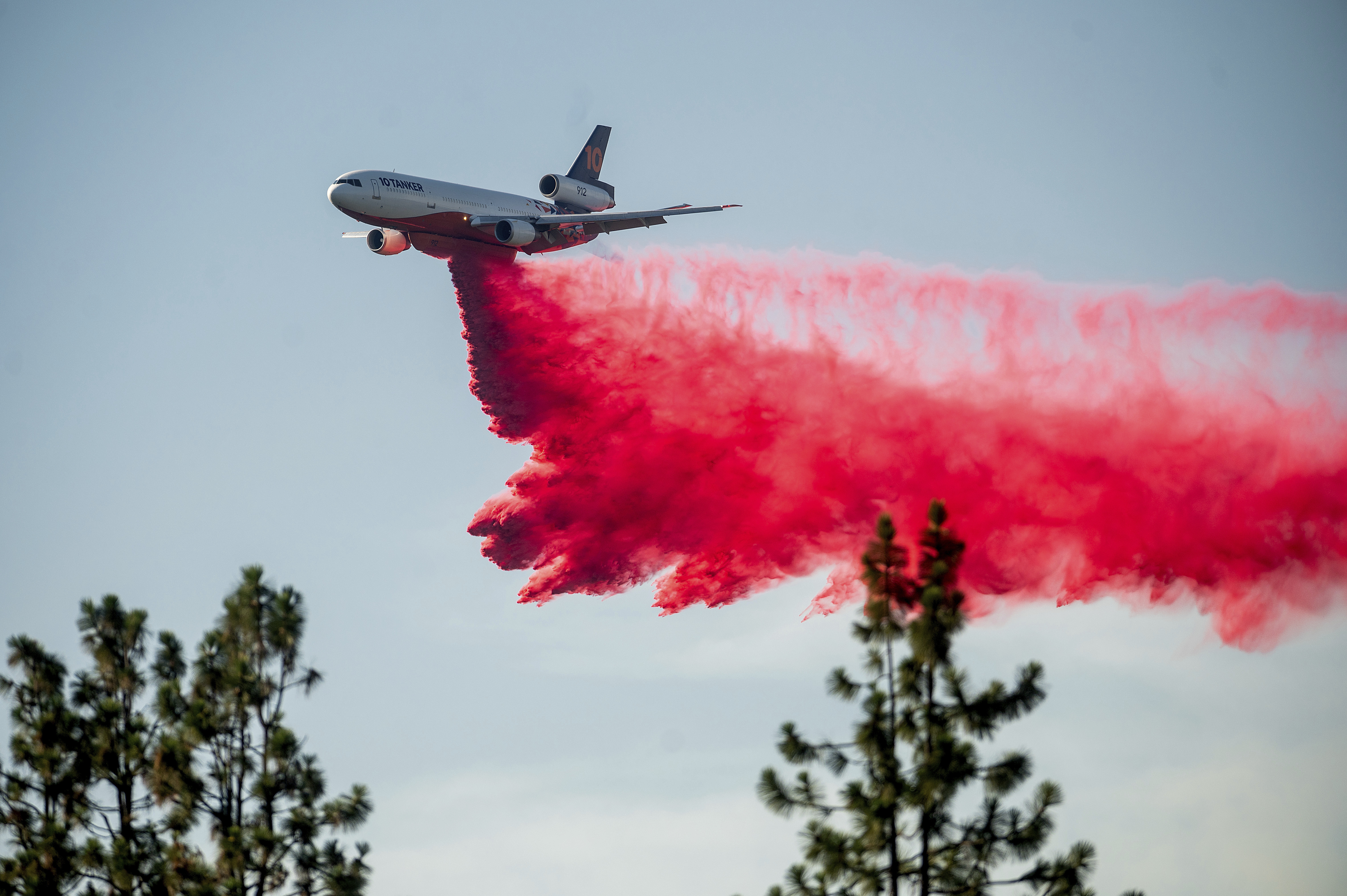 A DC-10 air tanker drops retardant while battling the Salt Fire near the Lakehead community of Unincorporated Shasta County, Calif., on Friday, July 2, 2021. (AP Photo/Noah Berger)