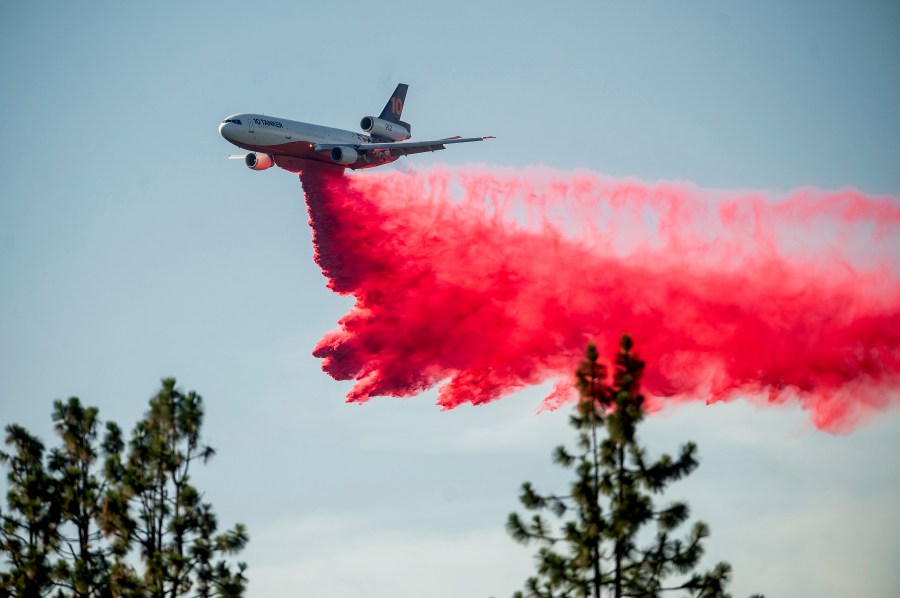 A DC-10 air tanker drops retardant while battling the Salt Fire near the Lakehead community of Unincorporated Shasta County, Calif., on Friday, July 2, 2021. (AP Photo/Noah Berger)