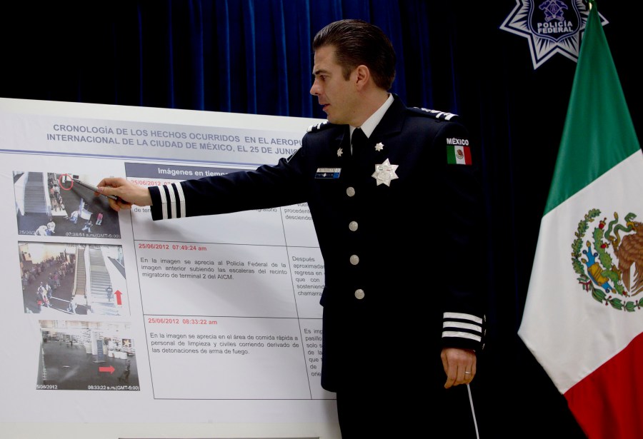 In this June 28, 2012 file photo, Luis Cardenas Palomino, chief of the regional security division of Mexico's federal police, points to surveillance camera footage at the international airport related to a shooting, during a press conference in Mexico City. Mexico said Monday, July 5, 2021, that it has arrested the former leading police officers on charges of torture from nearly a decade ago. (AP Photo/Esteban Felix, File)