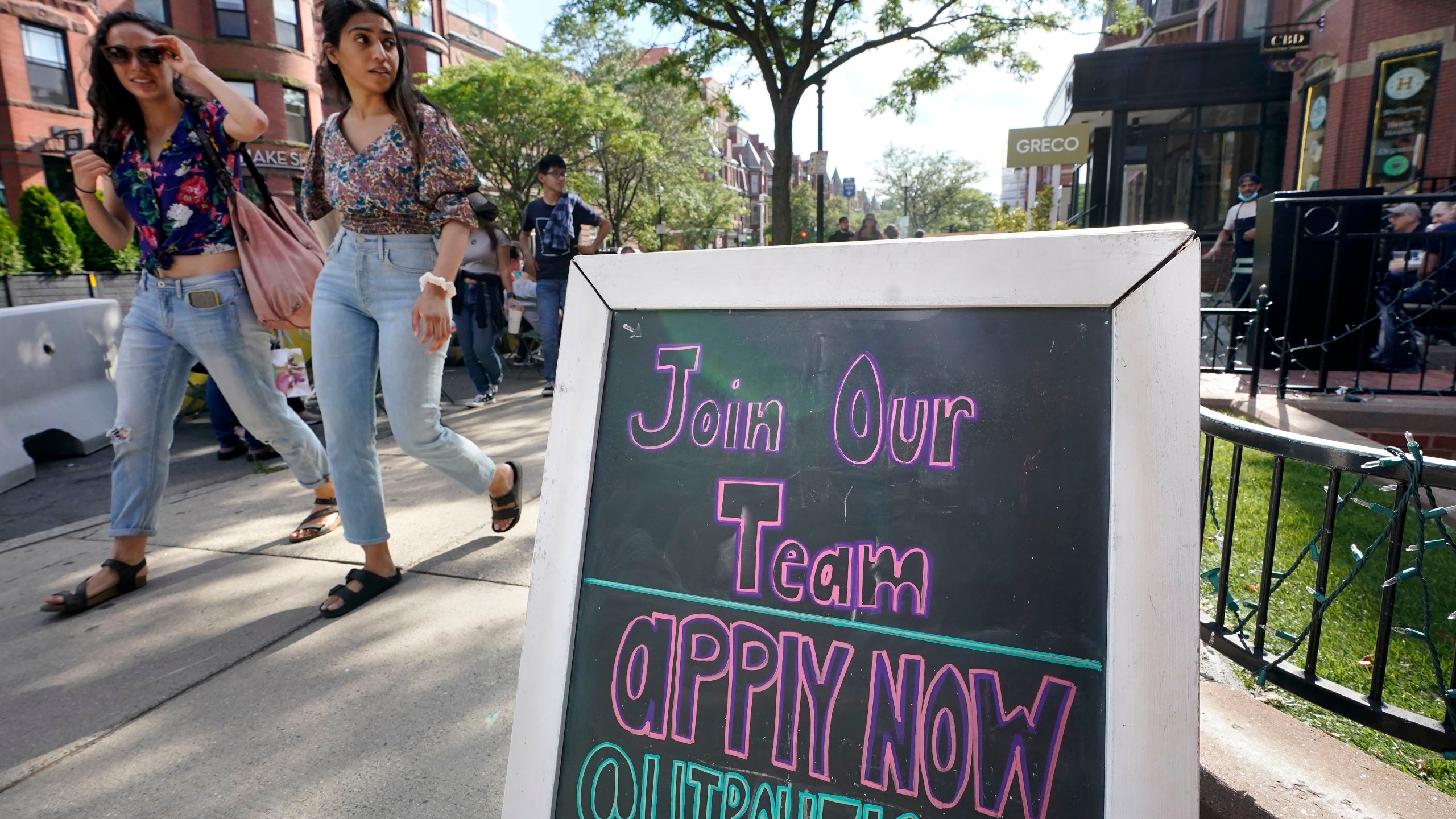 Pedestrians walk past a sign inviting people to apply for employment at a shop in Boston's fashionable Newbury Street neighborhood, Monday, July 5, 2021. As the U.S. economy bounds back with unexpected speed from the pandemic recession and customer demand intensifies, high school-age kids are filling jobs that older workers can’t — or won’t. (AP Photo/Steven Senne)