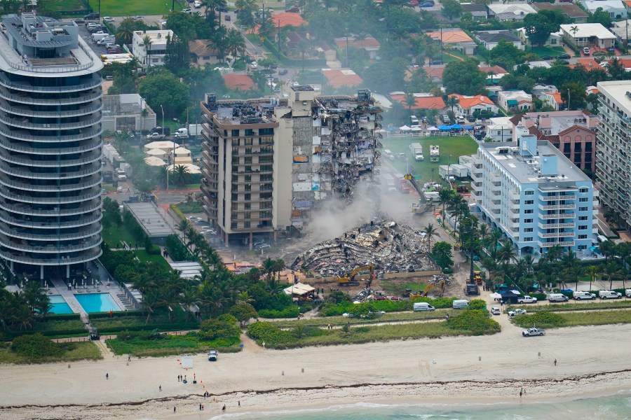 In this Friday, June 25, 2021, file photo, rescue personnel work in the rubble at the Champlain Towers South Condo, in Surfside, Fla. Even as the search continues over a week later for signs of life in the mangled debris of the fallen Champlain Towers South, the process of seeking answers about why it happened and who is to blame is already underway in Florida's legal system. (AP Photo/Gerald Herbert, File)