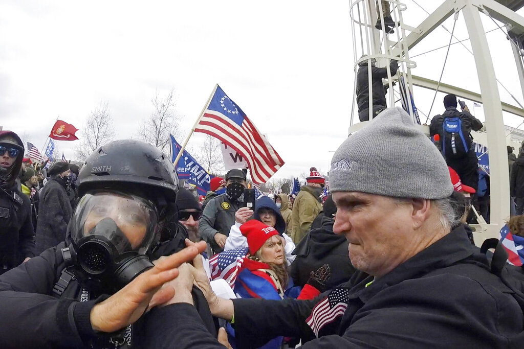 In this Jan. 6, 2021, image from video, Alan William Byerly, right, is seen allegedly attacking an Associated Press photographer during a riot at the U.S. Capitol in Washington. (AP Photo/Julio Cortez)