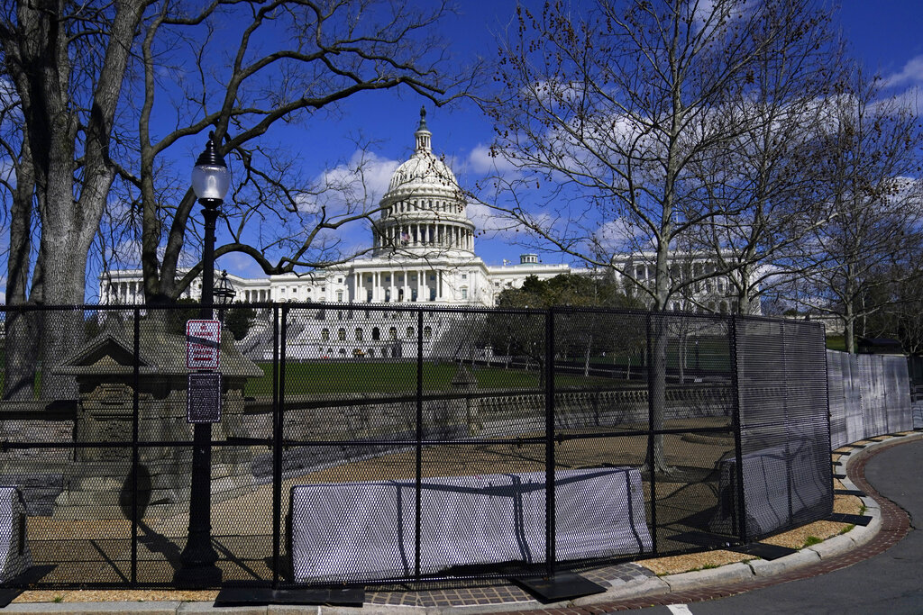 In this April 2, 2021, file photo the U.S. Capitol is seen behind security fencing on Capitol Hill in Washington. (AP Photo/Carolyn Kaster, File)