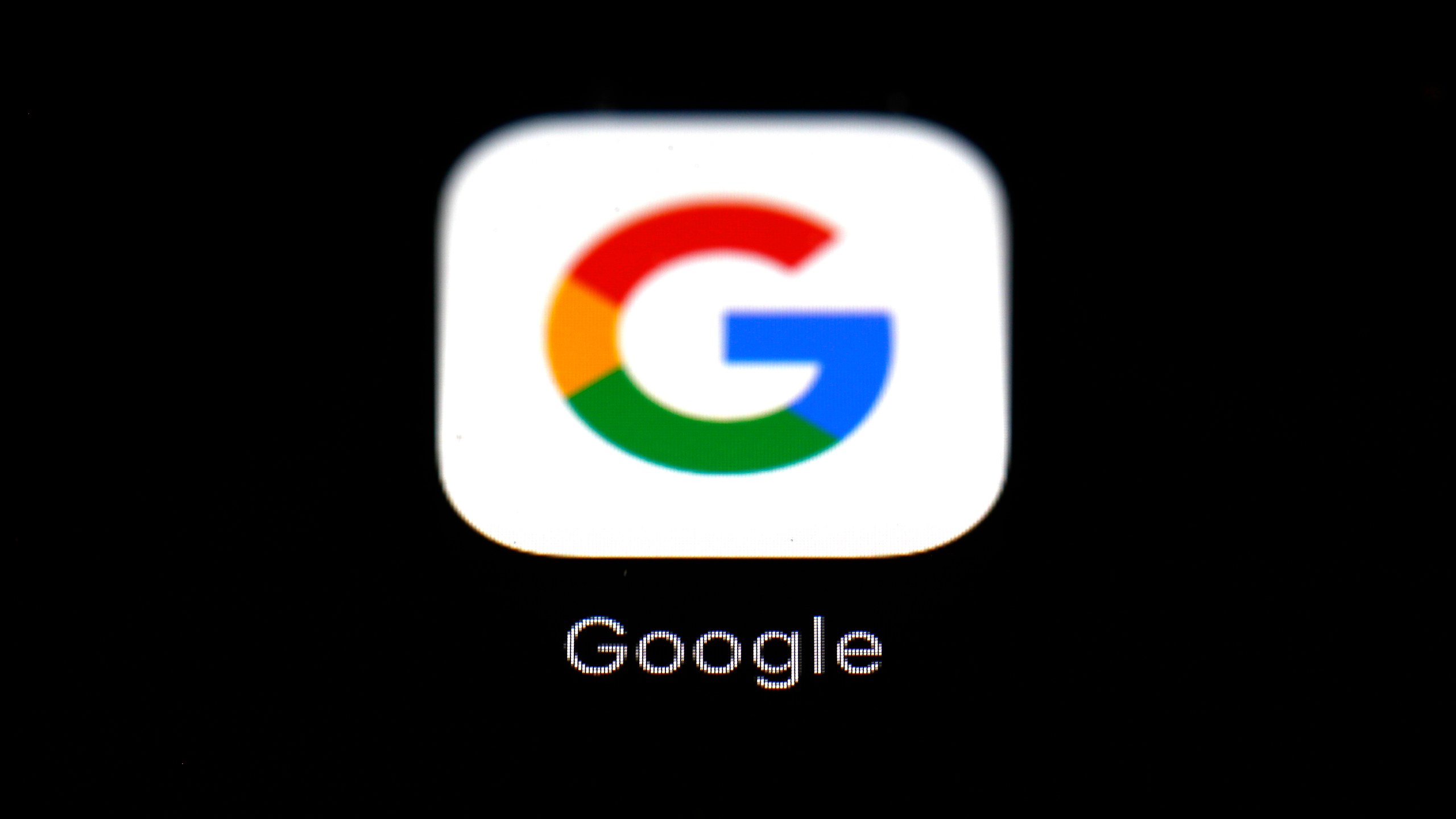 This March 19, 2018 file photo shows the Google app on an iPad in Baltimore. Dozens of states are taking aim at Google in an escalating legal offensive on Big Tech. This time it's a lawsuit targeting the Google's Play store, where consumers download most of the apps designed for the Android software that powers most of the world’s smartphones. The complaint filed late Wednesday, July 7, 2021 represents the fourth major antitrust filed against Google by government agencies across the U.S. since last October. (AP Photo/Patrick Semansky, File)