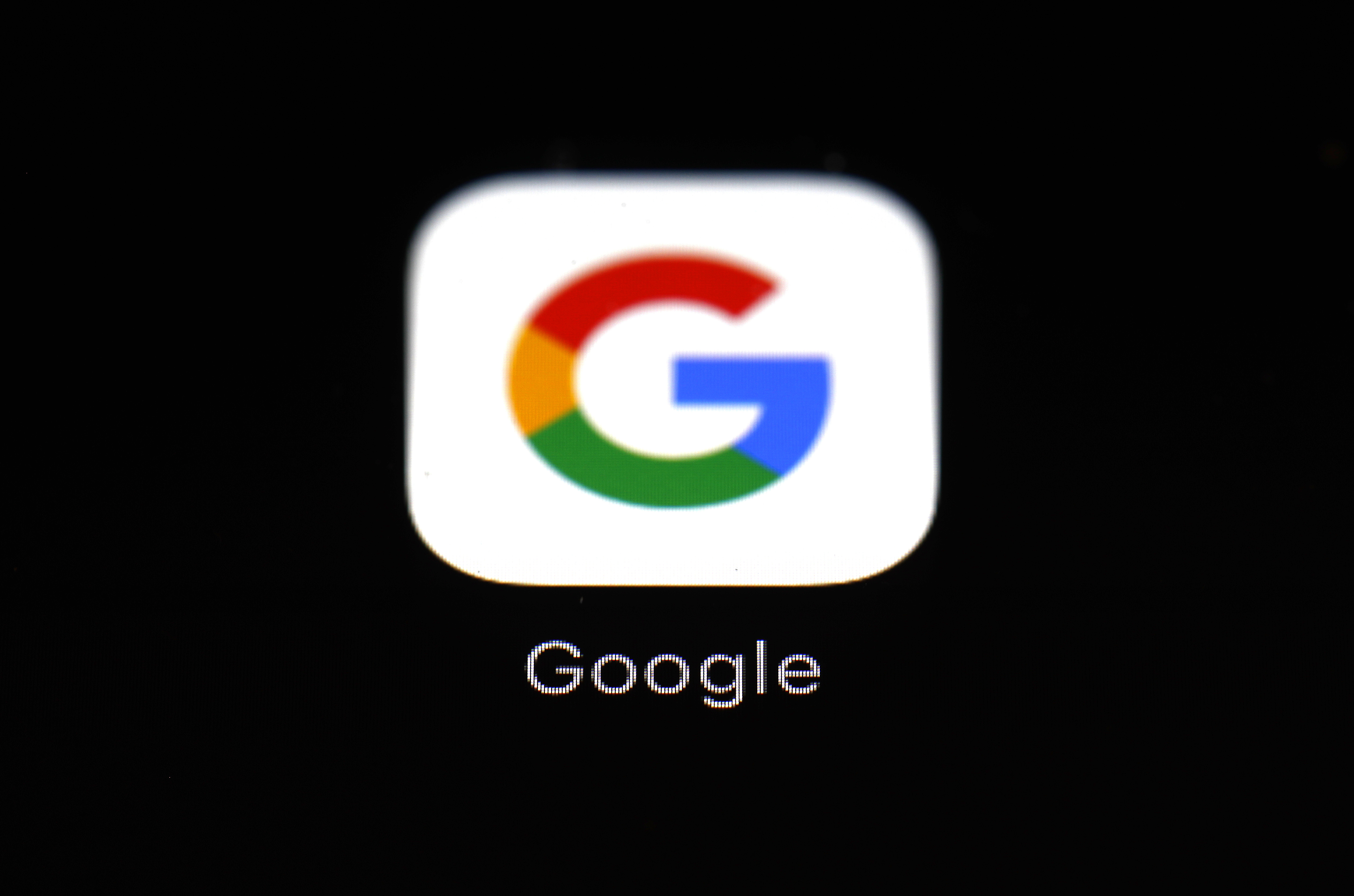 This March 19, 2018 file photo shows the Google app on an iPad in Baltimore. Dozens of states are taking aim at Google in an escalating legal offensive on Big Tech. This time it's a lawsuit targeting the Google's Play store, where consumers download most of the apps designed for the Android software that powers most of the world’s smartphones. The complaint filed late Wednesday, July 7, 2021 represents the fourth major antitrust filed against Google by government agencies across the U.S. since last October. (AP Photo/Patrick Semansky, File)