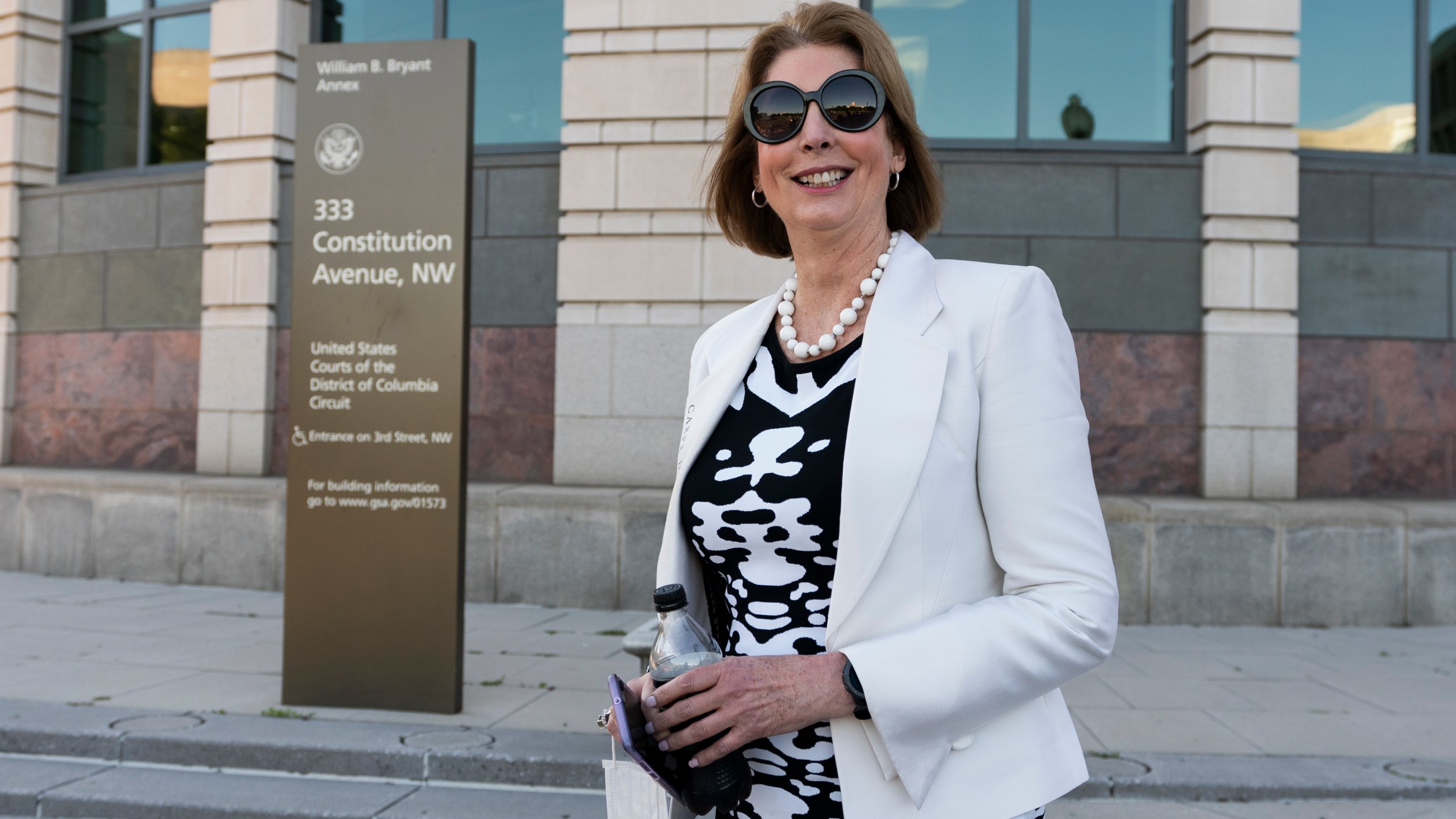 In this June 24, 2021, file photo, former President Donald Trump attorney Sidney Powell leaves federal court in Washington. A federal judge is considering whether to order financial penalties or other sanctions against some of Trump's lawyers, including Powell, who signed onto a lawsuit last year challenging Michigan's election results. (AP Photo/Manuel Balce Ceneta, File)