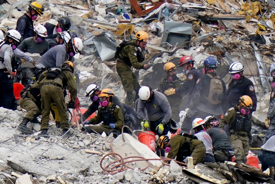 Crews from the United States and Israel work in the rubble Champlain Towers South condo, Tuesday, June 29, 2021, in Surfside, Fla. (AP Photo/Lynne Sladky, File)