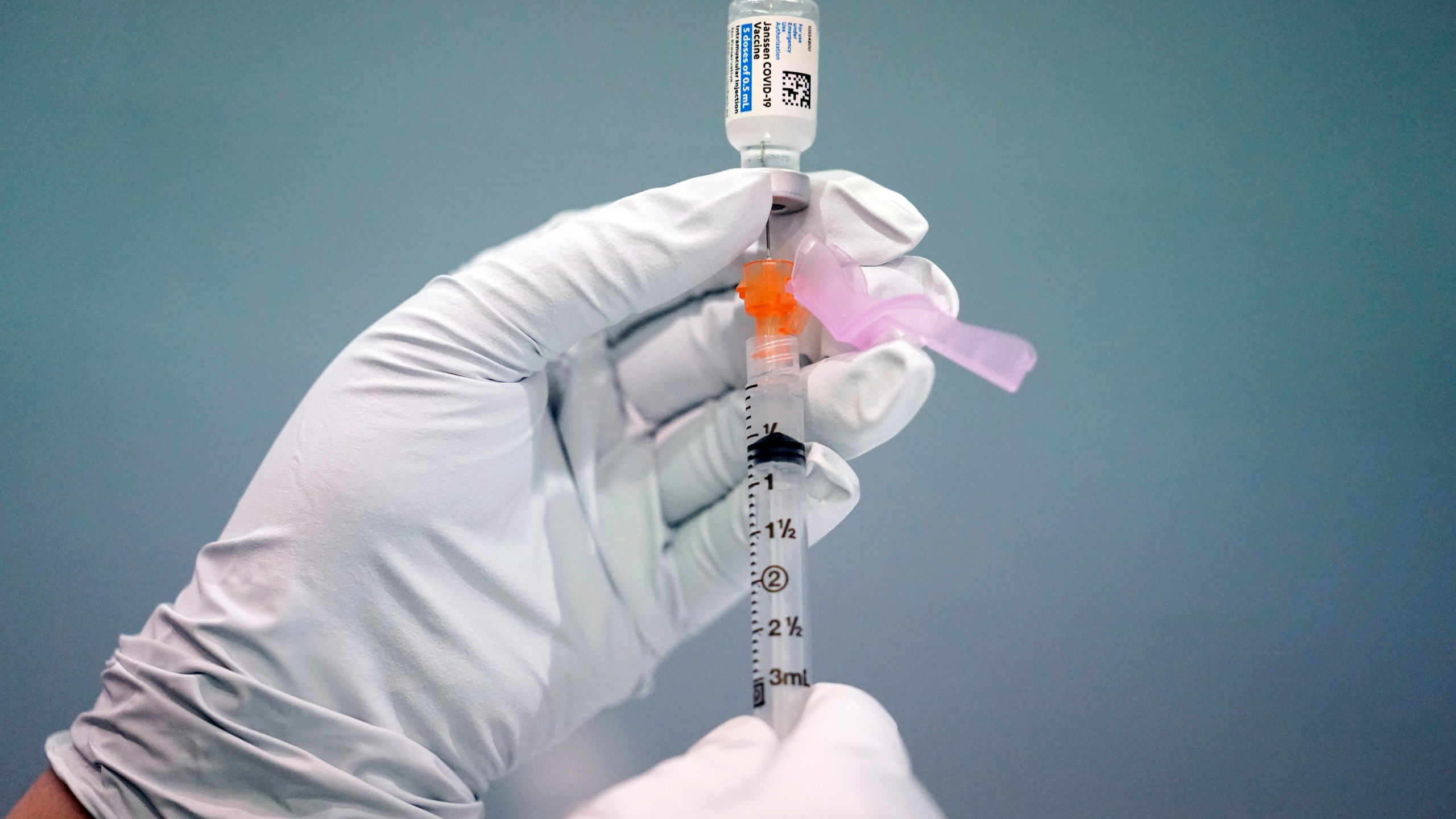 In this March 26, 2021, file photo a member of the Philadelphia Fire Department prepares a dose of the Johnson & Johnson COVID-19 vaccine at a vaccination site setup in Philadelphia. (AP Photo/Matt Rourke, File)