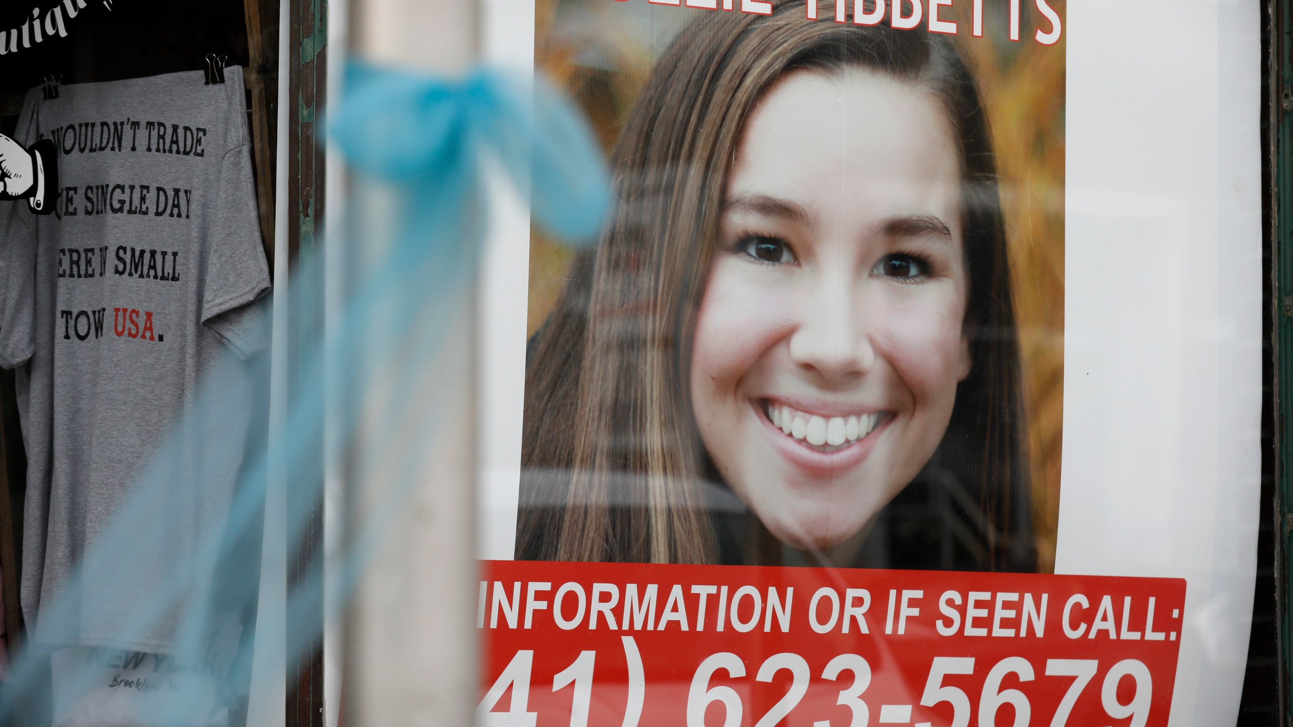 A poster for missing University of Iowa student Mollie Tibbetts hangs in the window of a local business in Brooklyn, Iowa, on Aug. 21, 2018. (Charlie Neibergall / Associated Press)