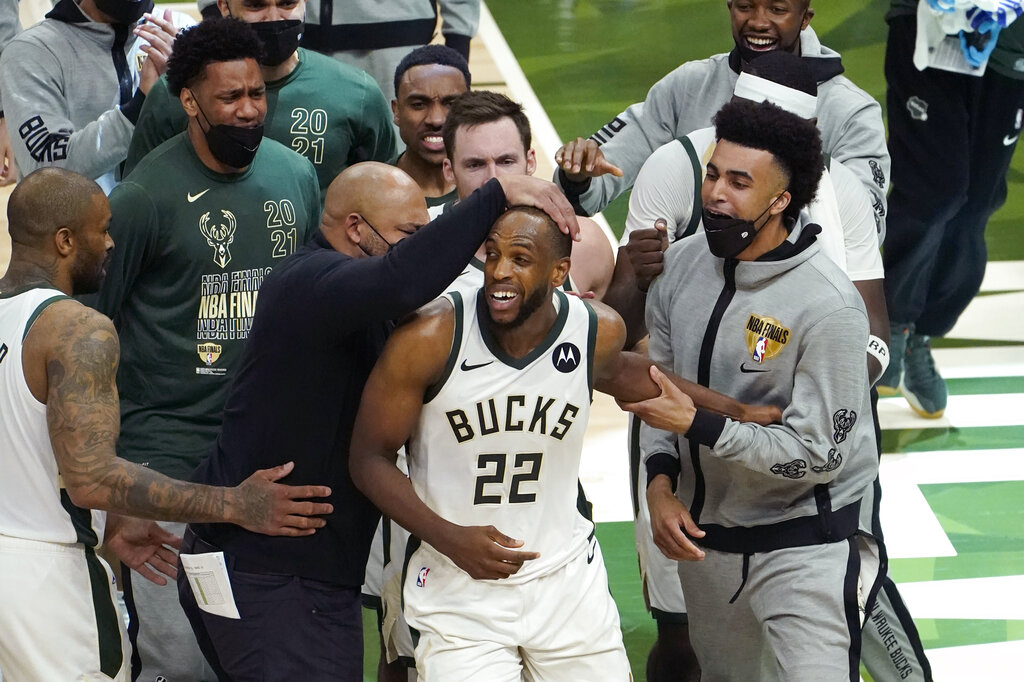 Milwaukee Bucks forward Khris Middleton (22) celebrates with teammates during the second half against the Phoenix Suns in Game 4 of basketball's NBA Finals in Milwaukee, Wednesday, July 14, 2021. (AP Photo/Paul Sancya)