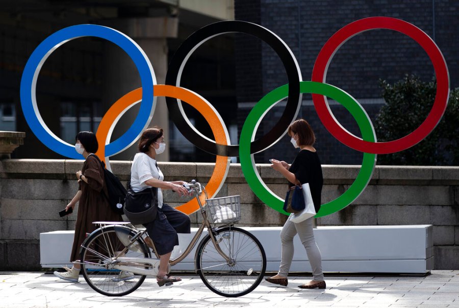 People walk by the Olympic rings installed by the Nippon Bashi bridge in Tokyo on Thursday, July 15, 2021. (AP Photo/Hiro Komae)