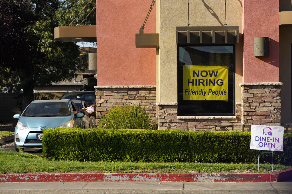 A hiring sign hangs in the window of a Taco Bell in Sacramento, Calif., Thursday, July 15, 2021. (AP Photo/Rich Pedroncelli))