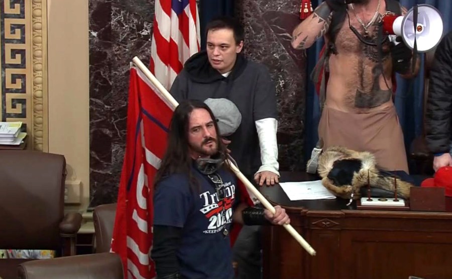 In this file image from U.S. Capitol Police video, Paul Allard Hodgkins, 38, of Tampa, Fla., front, stands in the well on the floor of the U.S. Senate on Jan. 6, 2021, at the Capitol in Washington. (U.S. Capitol Police via AP, File)