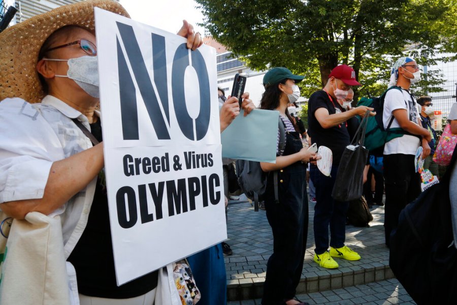 People gather for a rally in Tokyo's Shinjuku shopping district Sunday, July 18, 2021, to protest against the Olympics starting from July 23. (AP Photo/Yuri Kageyama)