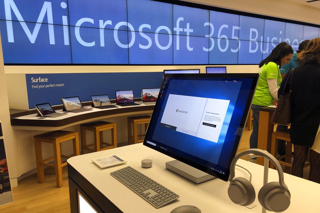 In this Jan. 28, 2020, file photo, a Microsoft computer is among items displayed at a Microsoft store in suburban Boston. (AP Photo/Steven Senne)