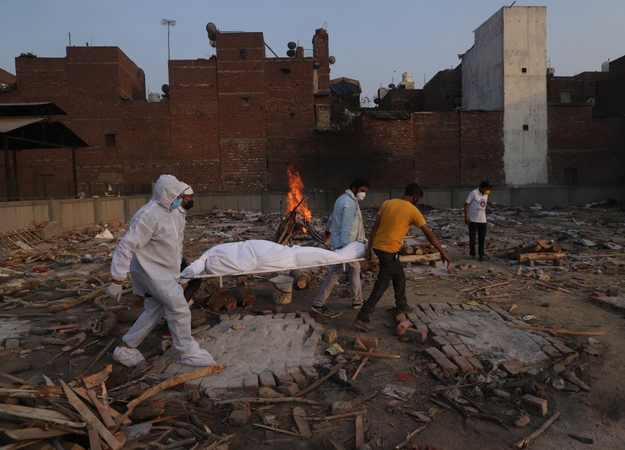 In this May 11, 2021, file photo, family members and volunteers carry the body of a COVID-19 victim for cremation in New Delhi, India. (Amit Sharma/Associated Press)