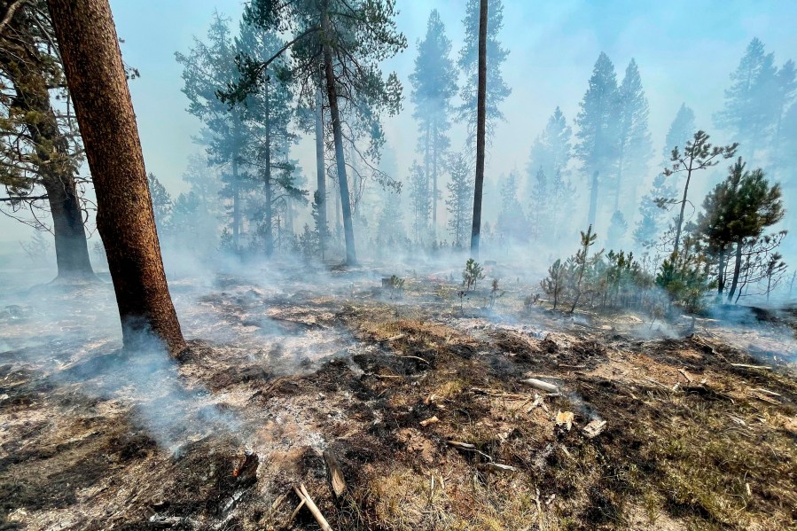 In this photo provided by the Bootleg Fire Incident Command, the Bootleg Fire is seen smoldering in southern Oregon, Saturday, July 17, 2021. The destructive Bootleg Fire, one of the largest in modern Oregon history, has already burned more than 476 square miles (1,210 square kilometers), an area about the size of Los Angeles. Meteorologists predicted critically dangerous fire weather through at least Monday with lightning possible in both California and southern Oregon. (Bootleg Fire Incident Command via AP)