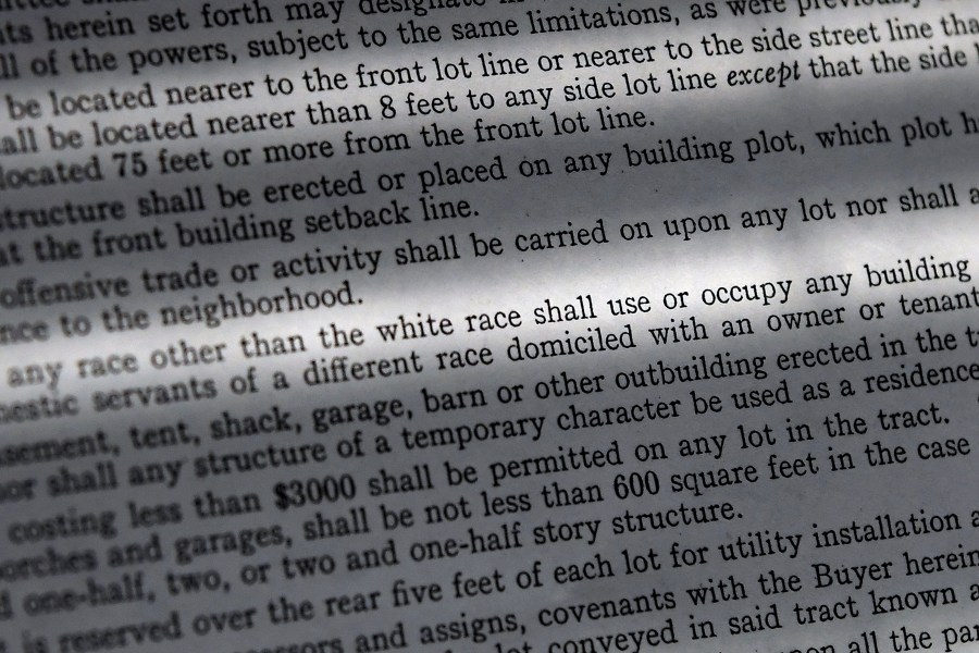 In this Saturday, July 17, 2021, photo, a copy of a covenant for property now owned by Fred Ware is seen in Manchester, Conn. Fred and Dave Ware recently found a whites-only covenant on his property dating back to 1942 when researching the title chain. The covenant described as letter "F" states that "No persons of any race other than the white race shall use or occupy any building or any lot, except that this covenant shall not prevent occupancy by domestic servants of a different race domiciled with an owner tenant." (AP Photo/Jessica Hill)