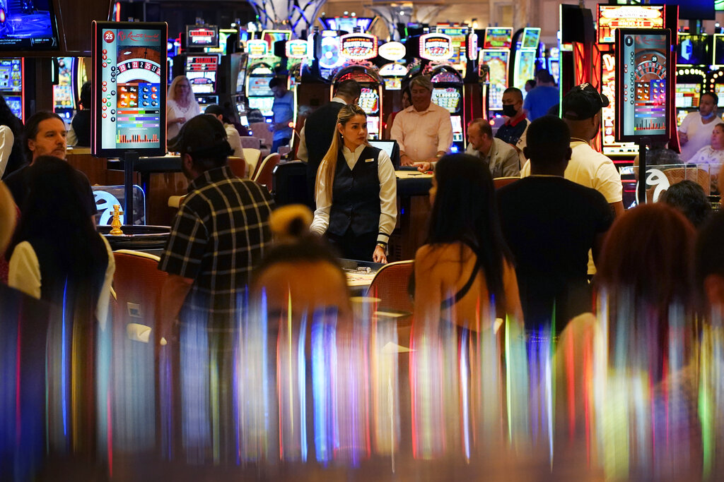 In this June 24, 2021, file photo, crowds walk through the casino during the opening night of Resorts World Las Vegas in Las Vegas. (AP Photo/John Locher, File)