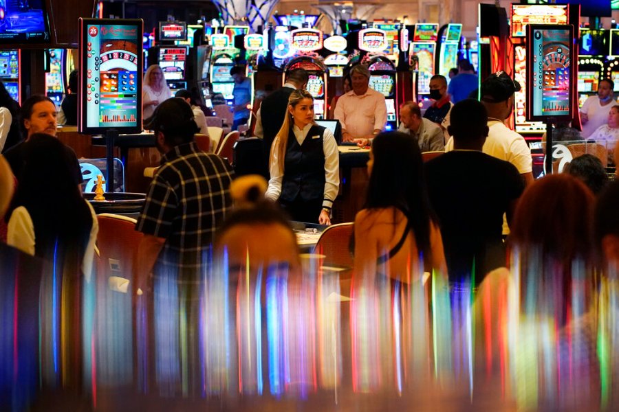 In this June 24, 2021, file photo, crowds walk through the casino during the opening night of Resorts World Las Vegas in Las Vegas. (AP Photo/John Locher, File)