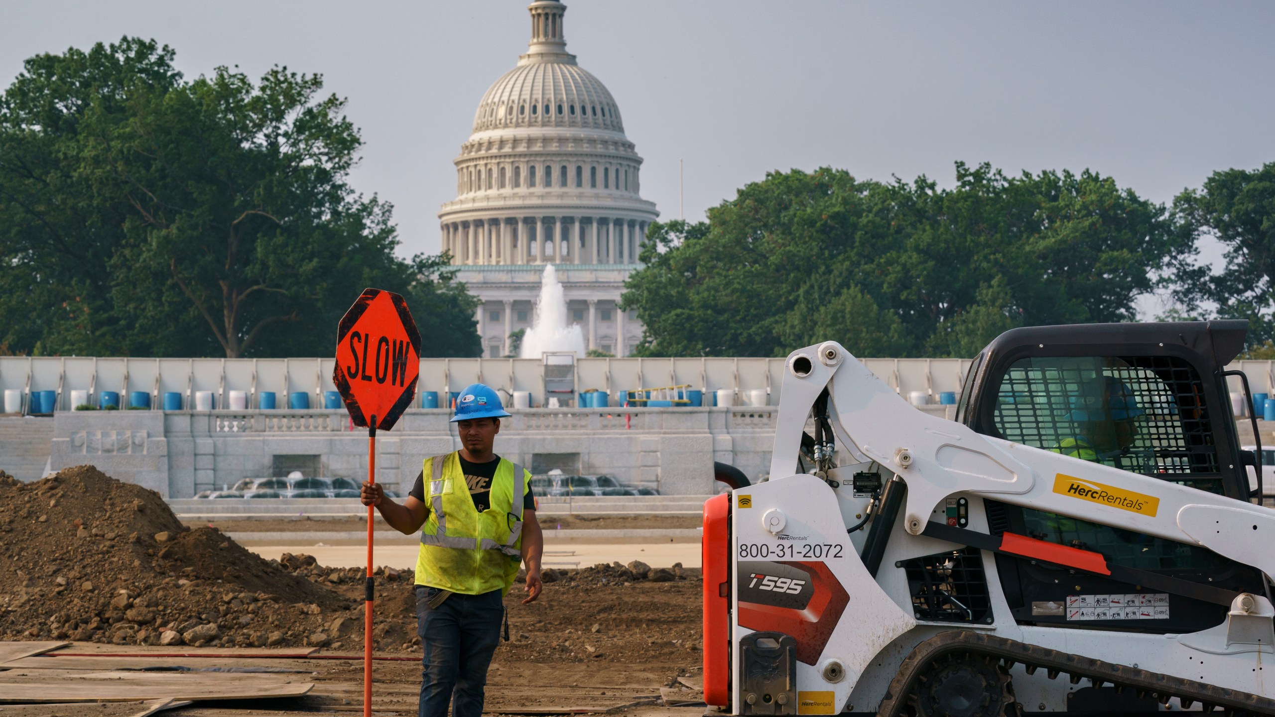 Workers repair a park near the Capitol in Washington, Wednesday, July 21, 2021, as senators struggle to reach a compromise over how to pay for nearly $1 trillion in public works spending, a key part of President Joe Biden's agenda. (AP Photo/J. Scott Applewhite)