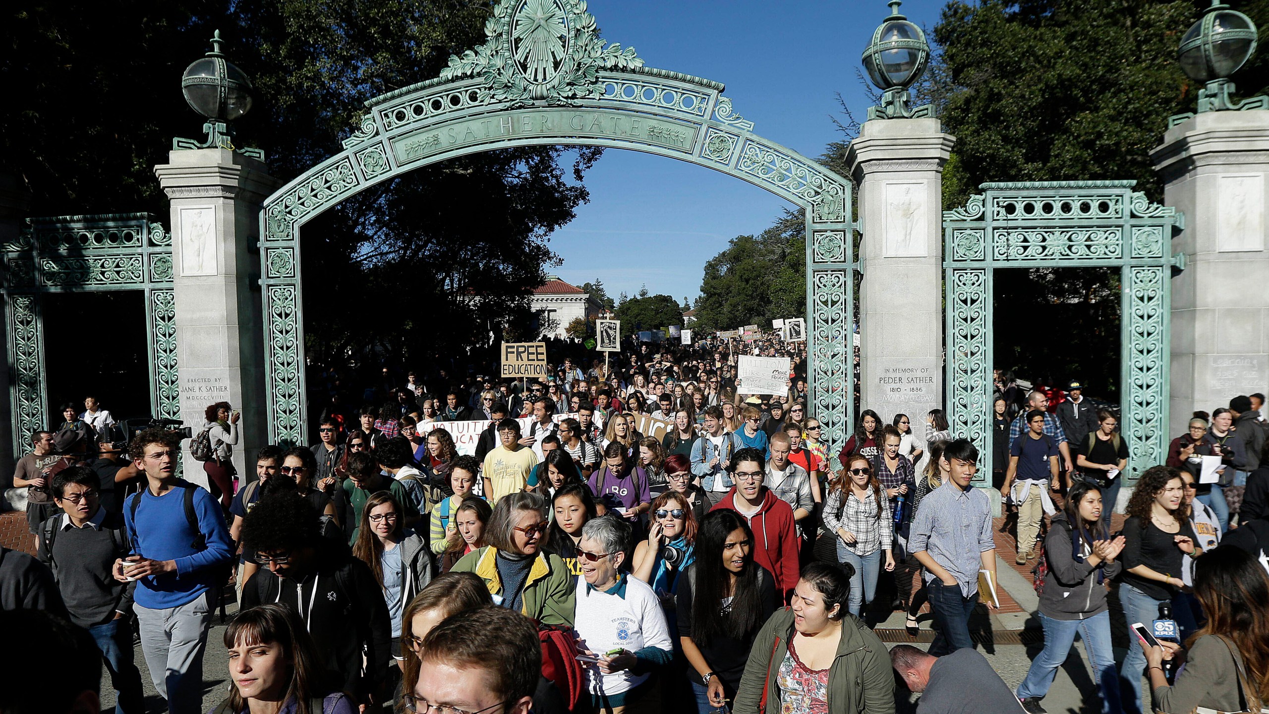 Students march under Sather Gate during a tuition-hike protest at the UC Berkeley on Nov. 24, 2014. (Jeff Chiu / Associated Press)