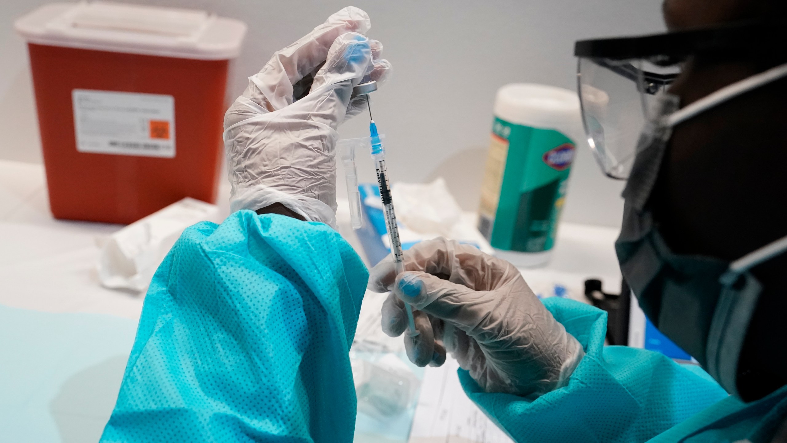 In this July 22, 2021 file photo, a health care worker fills a syringe with the Pfizer COVID-19 vaccine at the American Museum of Natural History in New York. (AP Photo/Mary Altaffer)