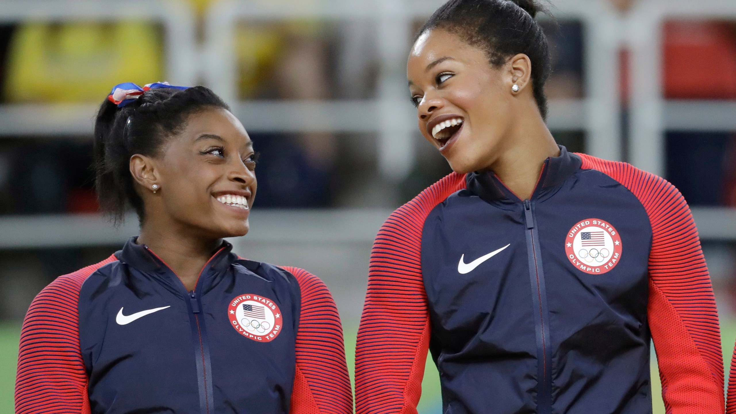 In this Aug. 9, 2016, file photo, U.S. gymnasts and gold medallists, Simone Biles, left and Gabrielle Douglas celebrate on the podium during the medal ceremony for the artistic gymnastics women's team at the 2016 Summer Olympics in Rio de Janeiro, Brazil. The success of Olympic gymnastics champions Gabby Douglas and Simone Biles has created a spike in interest in the sport in Black communities. Representation among Black girls at the upper reaches of women's gymnastics is rising. Half of the U.S. Olympic team in Tokyo are women of color. (AP Photo/Julio Cortez, File)