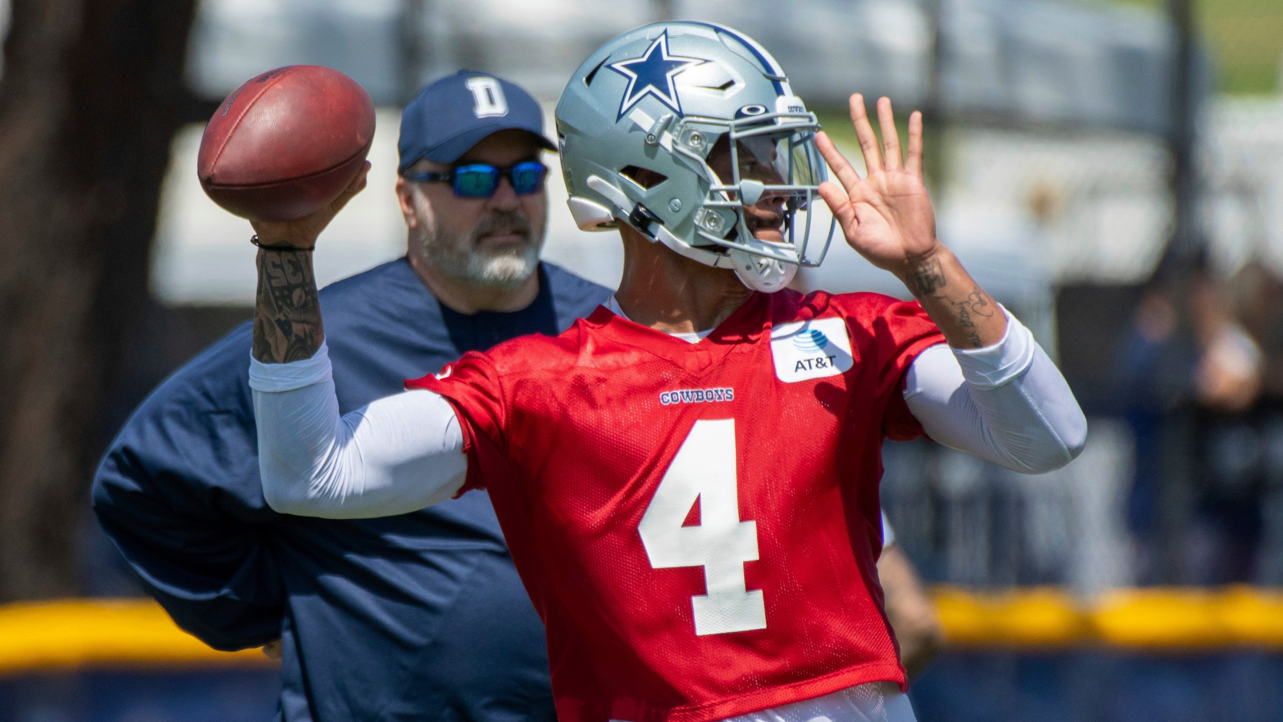 Dallas Cowboys quarterback Dak Prescott throws a pass as coach Mike McCarthy watches during the NFL football team's training camp in Oxnard, Calif., in this Thursday, July 22, 2021, file photo. (AP Photo/Michael Owen Baker, File)