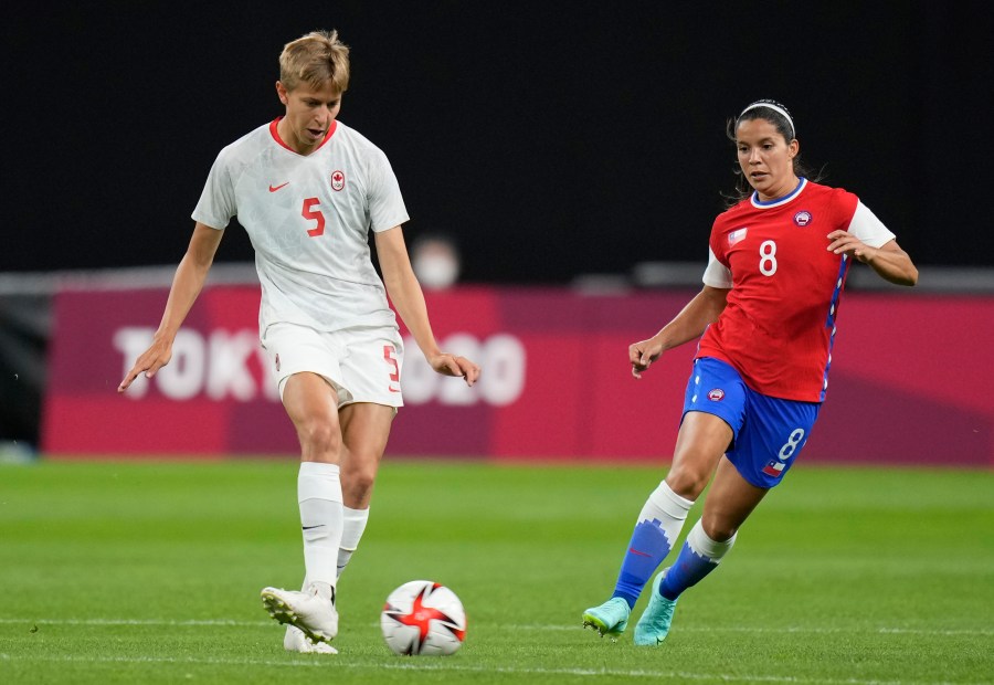 Canada's Quinn, left, and Chile's Karen Araya vie for the ball during a women's soccer match at the 2020 Summer Olympics, Saturday, July 24, 2021, in Sapporo, Japan. (AP Photo/Silvia Izquierdo)