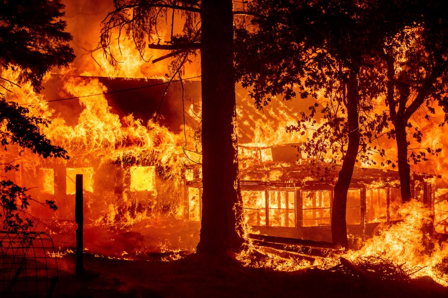 Flames from the Dixie Fire consume a home in the Indian Falls community of Plumas County, Calif., Saturday, July 24, 2021. (AP Photo/Noah Berger)