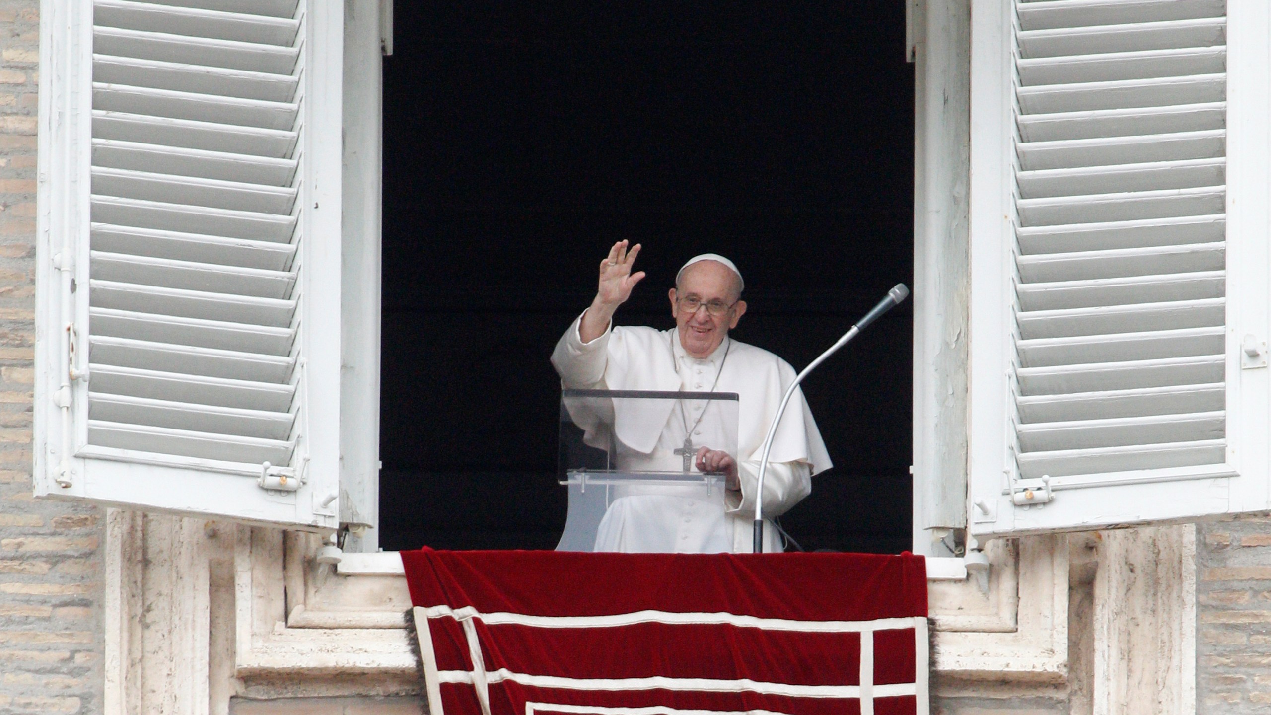 Pope Francis waves from his studio's window overlooking St. Peter's Square to celebrate the Angelus prayer, at the Vatican, Sunday, July 25, 2021. (AP Photo/Riccardo De Luca)