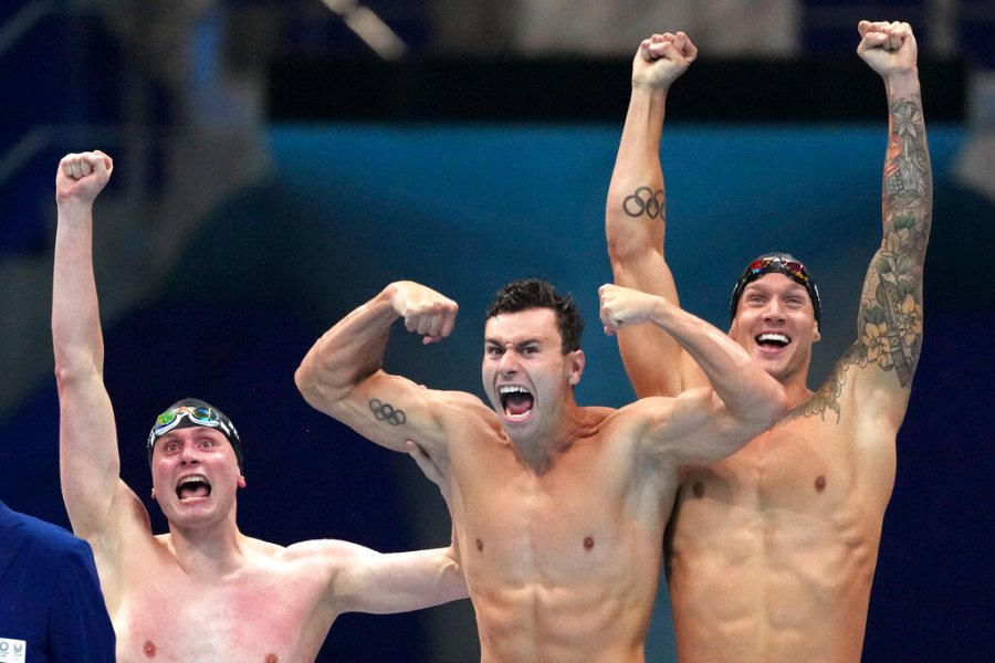 United States men's 4x100m freestyle relay team Bowen Beck, Blake Pieroni, and Caeleb Dressel celebrate after winning the gold medal at the 2020 Summer Olympics, Monday, July 26, 2021, in Tokyo, Japan. (AP Photo/Matthias Schrader)