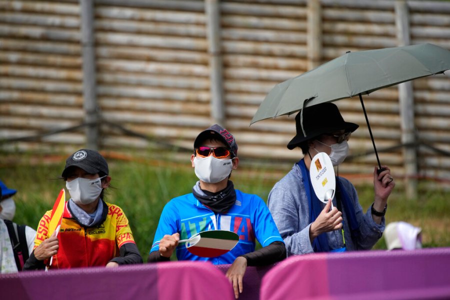 Supporters use fans to beat the heat at the men's cross country mountain biking at the 2020 Summer Olympics, Monday, July 26, 2021, in Izu, Japan. (AP Photo/Christophe Ena)