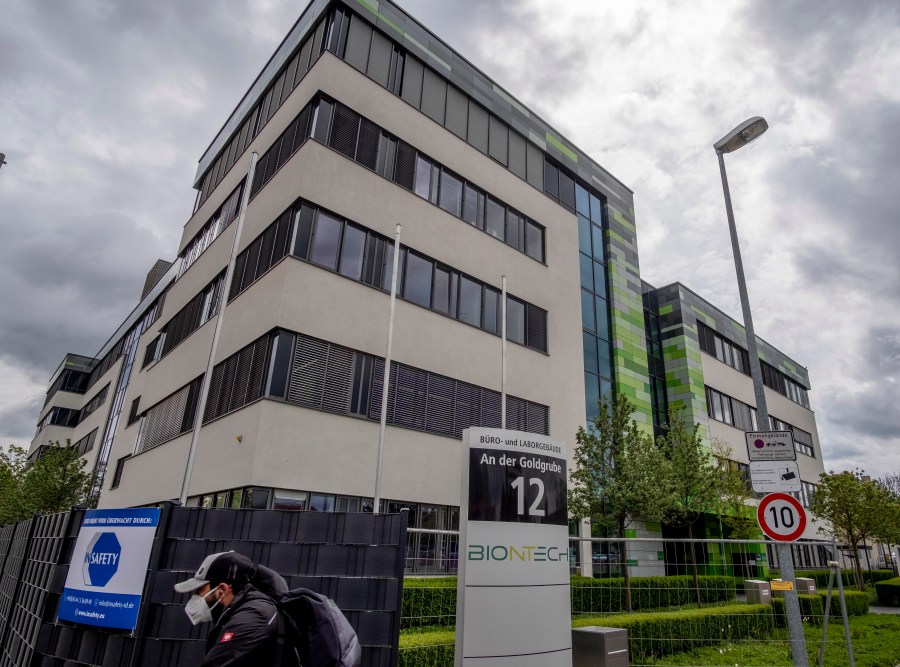 In this May 6, 2021 file photo a man with a face mask leaves the headquarters of the German biotechnology company "BioNTech" in Mainz, Germany. (AP Photo/Michael Probst, file)