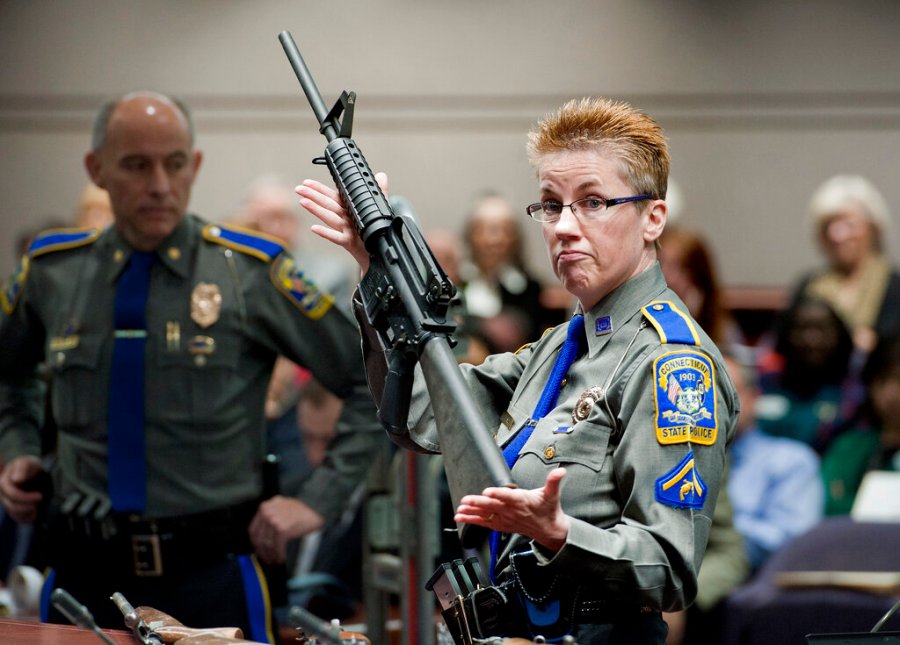 In this Jan. 28, 2013, file photo, firearms training unit Detective Barbara J. Mattson, of the Connecticut State Police, holds up a Bushmaster AR-15 rifle. (AP Photo/Jessica Hill, File)