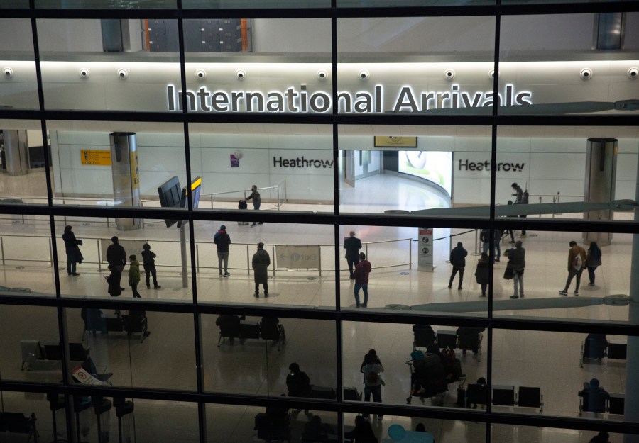 In this file photo dated Tuesday, Jan. 26, 2021, people in the International Arrivals area at Heathrow Airport in London, during England's coronavirus lockdown. The British government has said that starting upcoming Monday Aug. 2, 2021, fully vaccinated travellers from the United States and much of Europe will be able to enter England without the need for quarantining. (AP Photo/Matt Dunham, FILE)