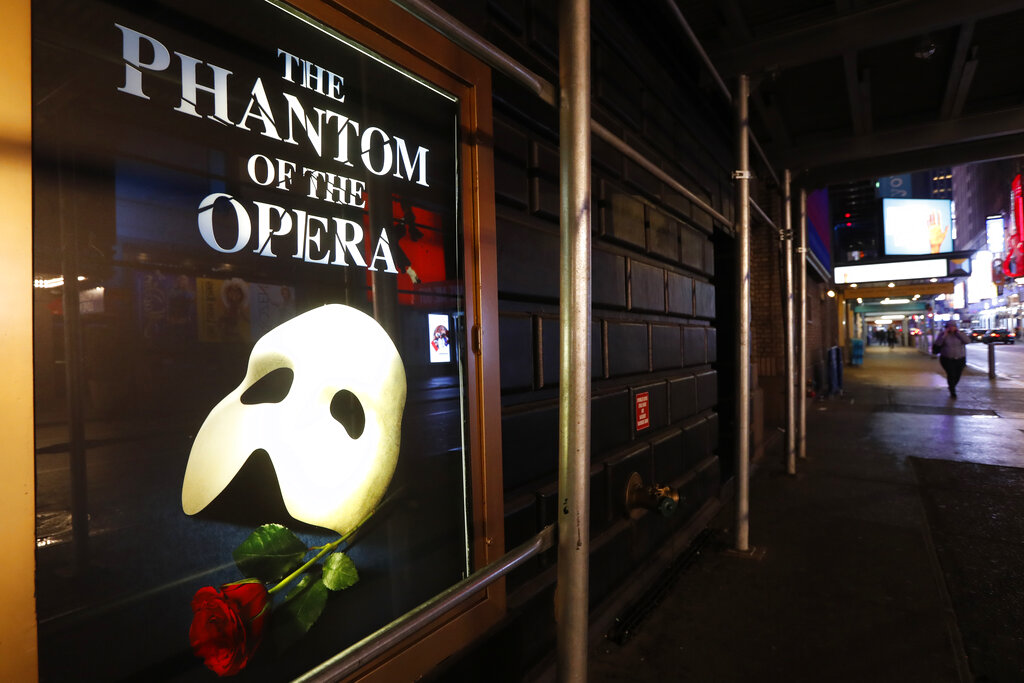 In this March 12, 2020, file photo, a poster advertising "The Phantom of the Opera" is displayed on the shuttered Majestic Theatre in New York. (AP Photo/Kathy Willens)