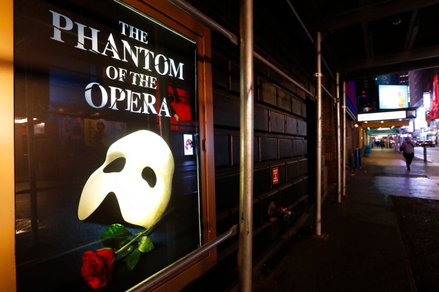 In this March 12, 2020, file photo, a poster advertising "The Phantom of the Opera" is displayed on the shuttered Majestic Theatre in New York. (AP Photo/Kathy Willens)