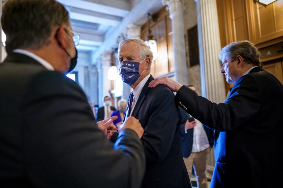 Sen. Angus King, I-Maine, center, speaks with Sen. Gary Peters, D-Mich., left, while Sen. John Kennedy, R-La., walks by at right, as the Senate votes to formally begin debate on a roughly $1 trillion infrastructure plan, a process that could take several days, at the Capitol in Washington, Friday, July 30, 2021. (AP Photo/J. Scott Applewhite)