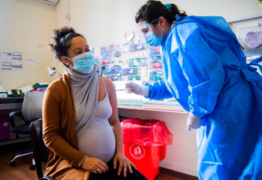 In this Wednesday, June 9, 2021 file photo, A nurse gives a shot of the Pfizer vaccine for COVID-19 to a pregnant woman in Montevideo, Uruguay. (AP Photo/Matilde Campodonico, File)