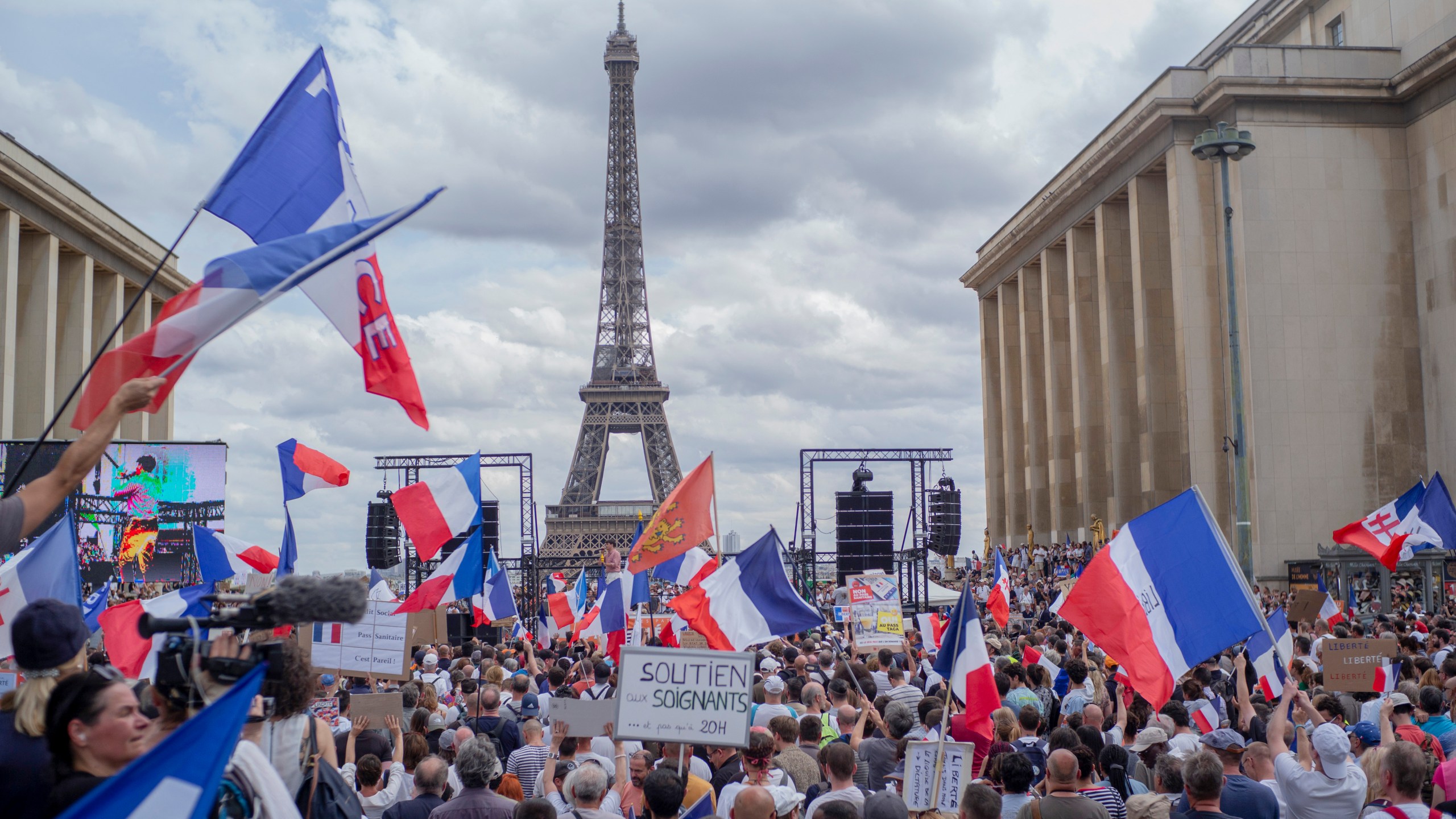 Thousands of protesters gather at Place Trocadero near the Eiffel Tower attend a demonstration in Paris, France, July 24, 2021, against the COVID-19 pass which grants vaccinated individuals greater ease of access to venues. (AP Photo/Rafael Yaghobzadeh)