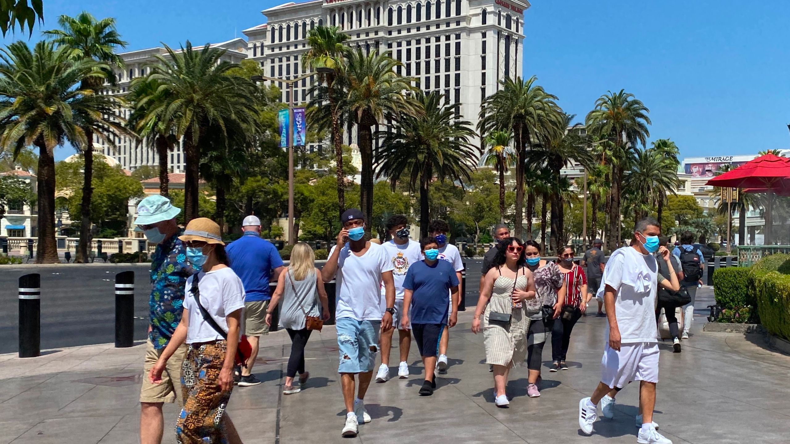 Tourists wear masks as they walk on the Strip in Las Vegas, Nevada, on Aug. 28, 2020. (DANIEL SLIM/AFP via Getty Images)