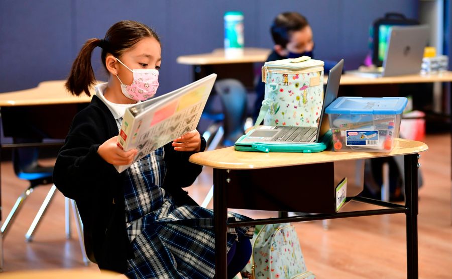 First grade students prepare for class at St. Joseph Catholic School in La Puente, California on Nov. 16, 2020 (FREDERIC J. BROWN/AFP via Getty Images)