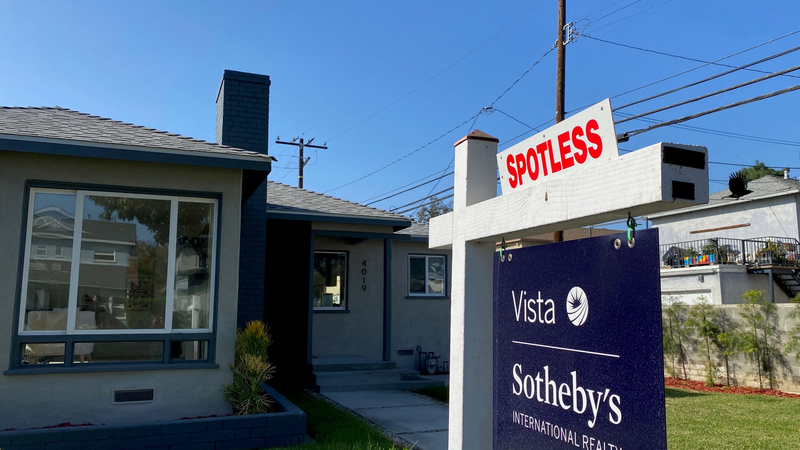 A real estate sign is seen in front of a house for sale in West Los Angeles in this file photo. (CHRIS DELMAS/AFP via Getty Images)