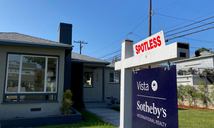 A real estate sign is seen in front of a house for sale in West Los Angeles in this file photo. (CHRIS DELMAS/AFP via Getty Images)